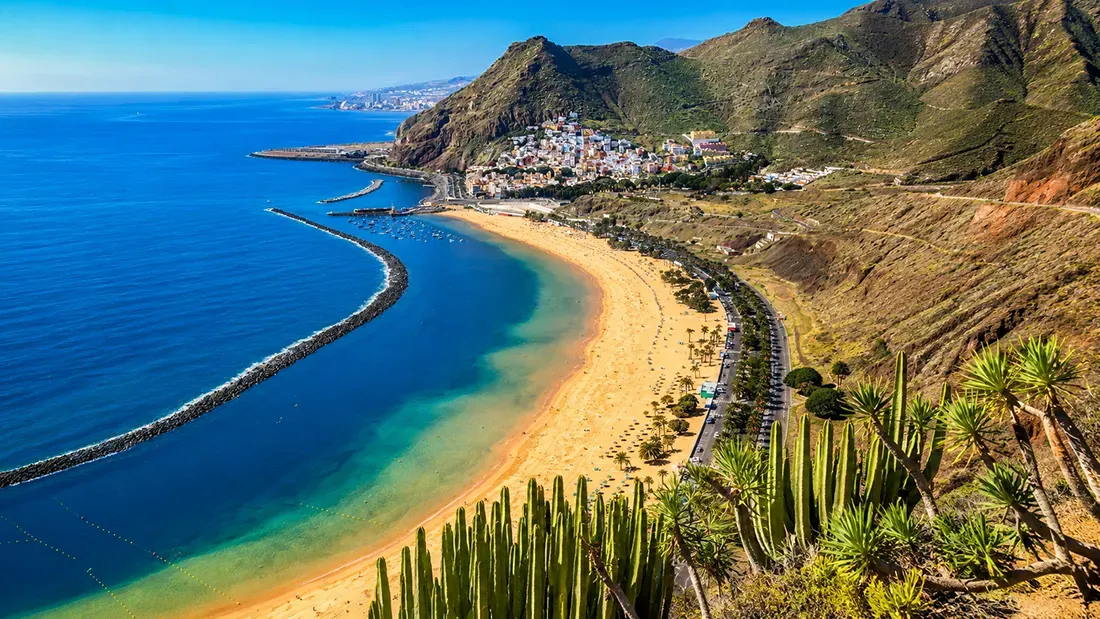 Aerial view of Tenerife's Las Teresitas beach with golden sand and turquoise waters