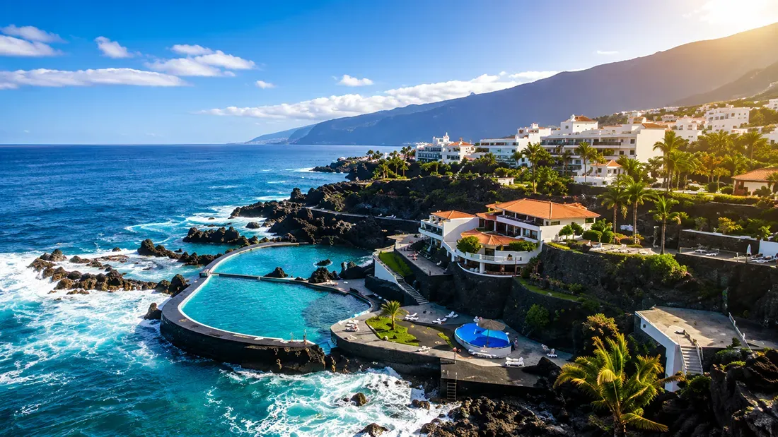 Coastal resort with natural pools overlooking turquoise ocean and mountains