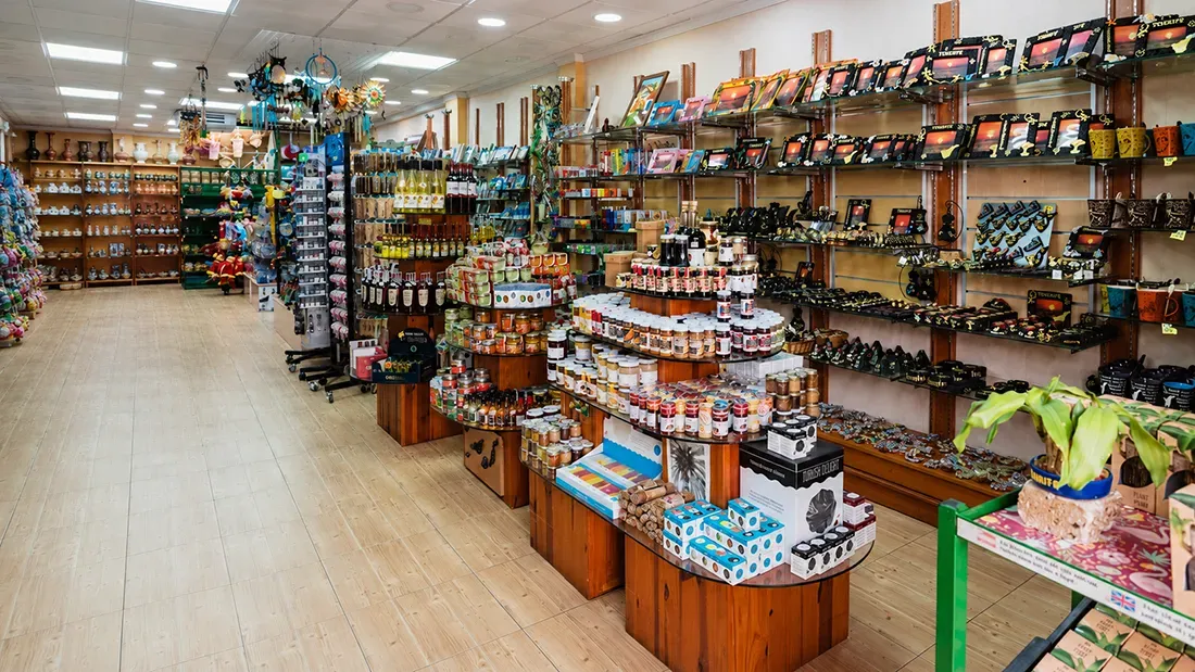 Interior of souvenir shop displaying crafts, electronics, and local products