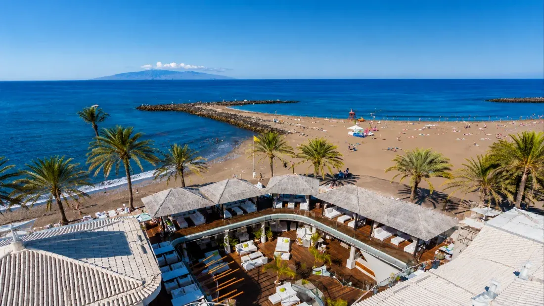 Beachfront resort with lounge area overlooking Tenerife coast and Mount Teide